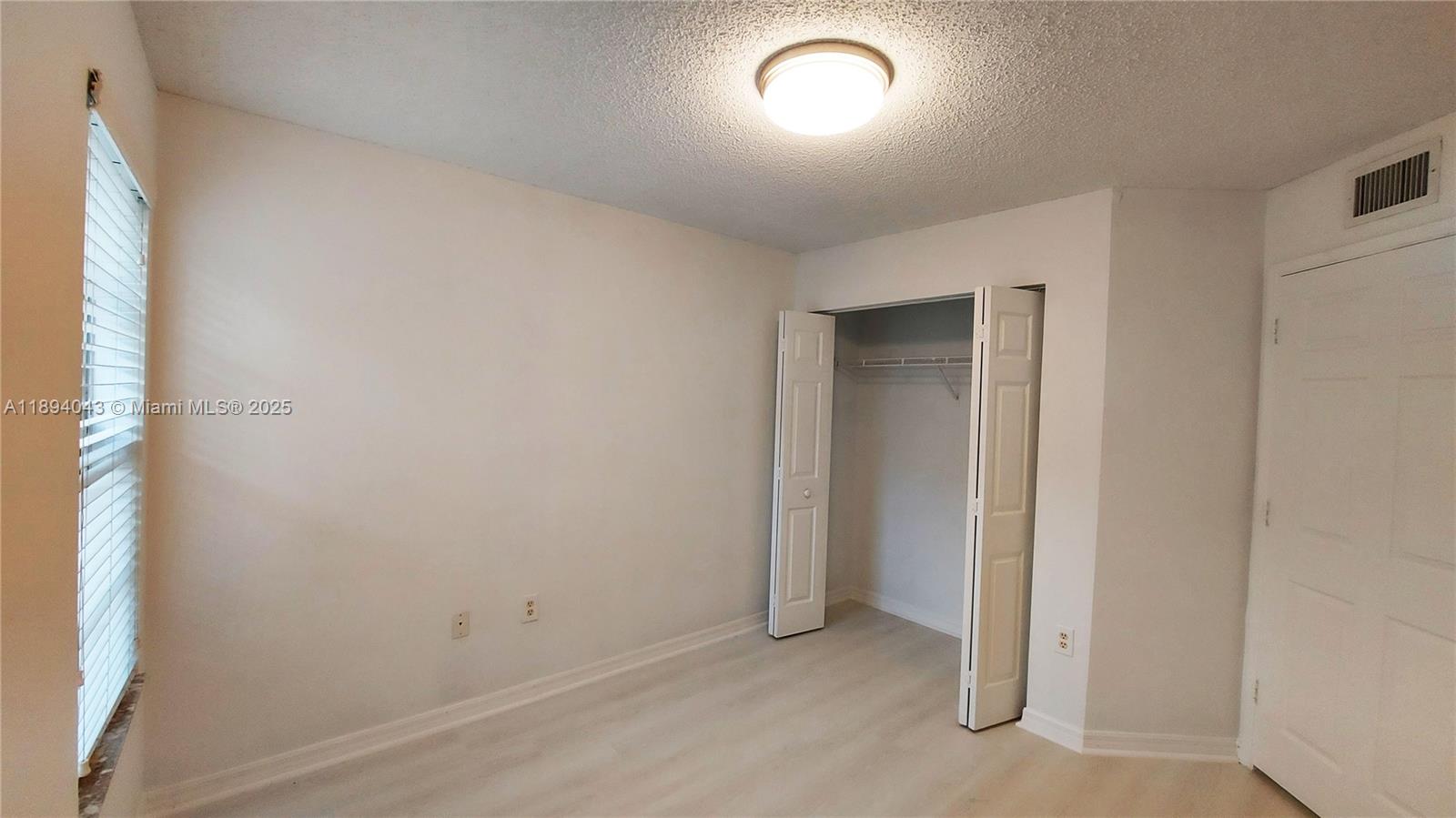 2457 Centergate Drive, Unit 108 Miramar, FL 33025 - Photo 17 of 18 an empty room with a natural light