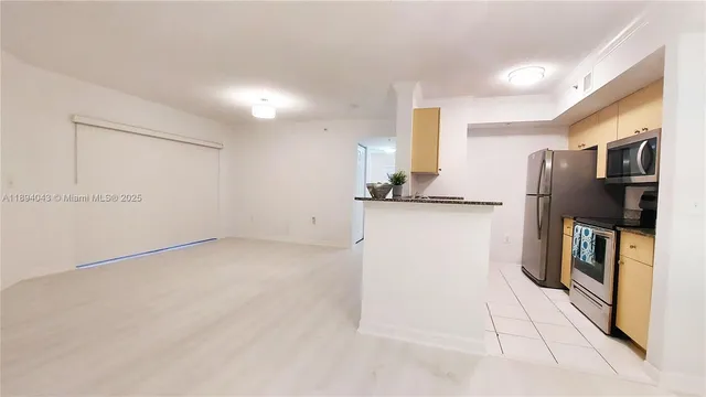 a kitchen with stainless steel appliances a refrigerator and a sink