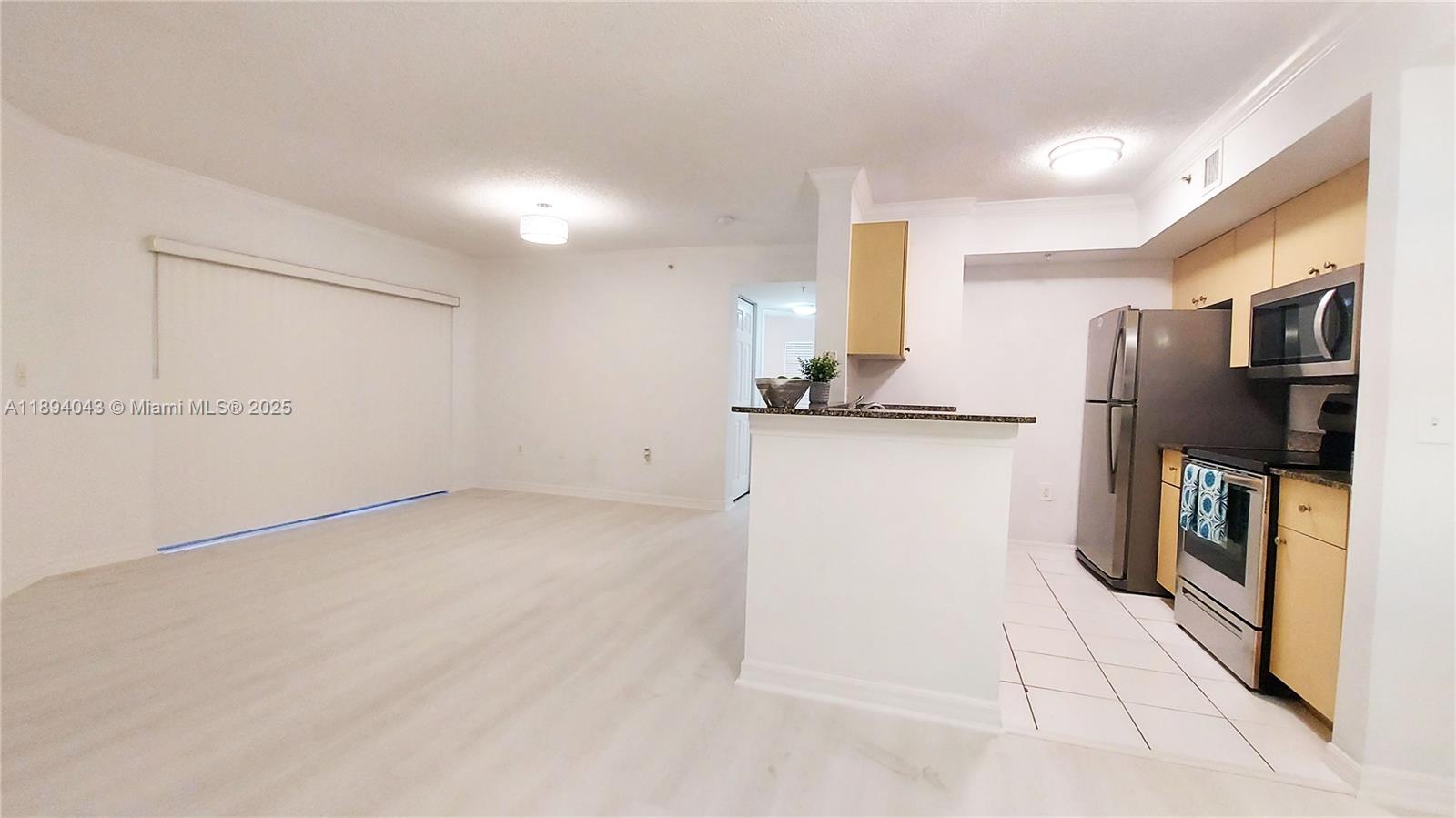 2457 Centergate Drive, Unit 108 Miramar, FL 33025 - Photo 3 of 18 a kitchen with stainless steel appliances a refrigerator and a sink