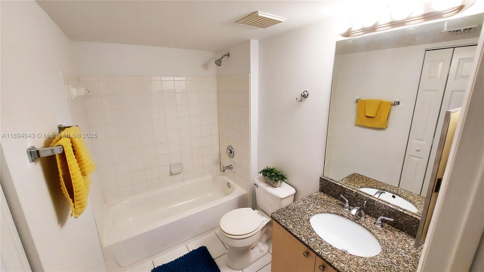 2457 Centergate Drive, Unit 108 Miramar, FL 33025 - Photo 10 of 18 a bathroom with a granite countertop sink toilet and shower