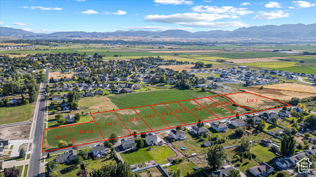 294 West 3400 South, Unit 9 Logan, UT 84321 - Photo 20 of 24 Aerial perspective of suburban area featuring a mountainous background and property parcel outlined