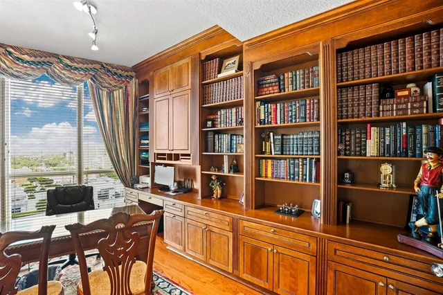 a work place with a bookshelf and a window