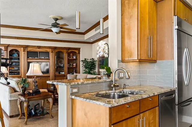 a kitchen with a sink a counter top space and cabinets