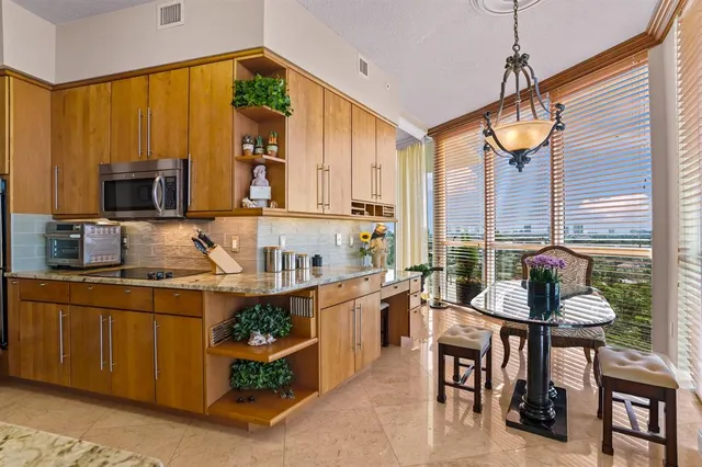 a kitchen with a stove a sink and cabinets