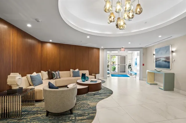a living room with furniture and a chandelier