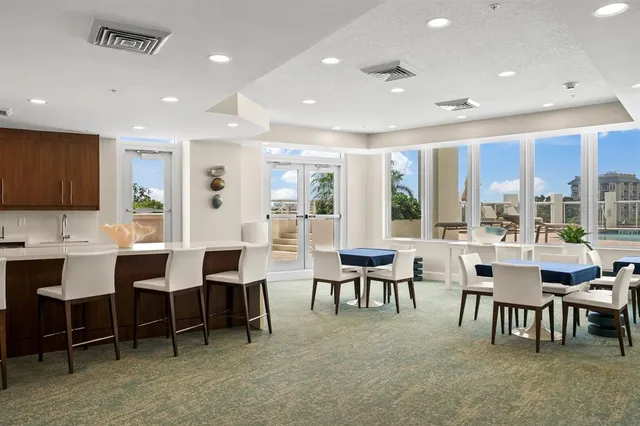 a large dining space with furniture and window