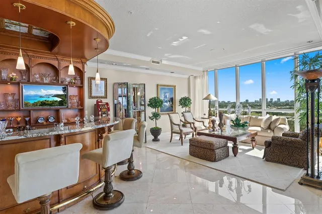a living room with furniture a rug and a large window