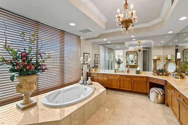 a large white kitchen with a large window
