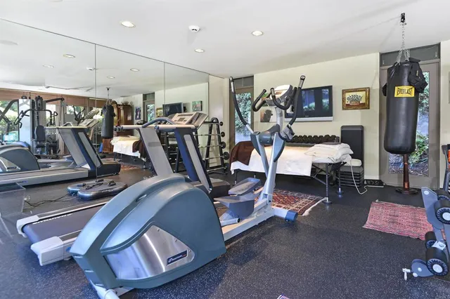 a dining room with furniture a chandelier and wooden floor