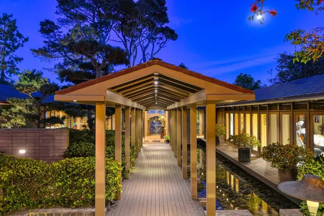 a living room with furniture a rug and a large window