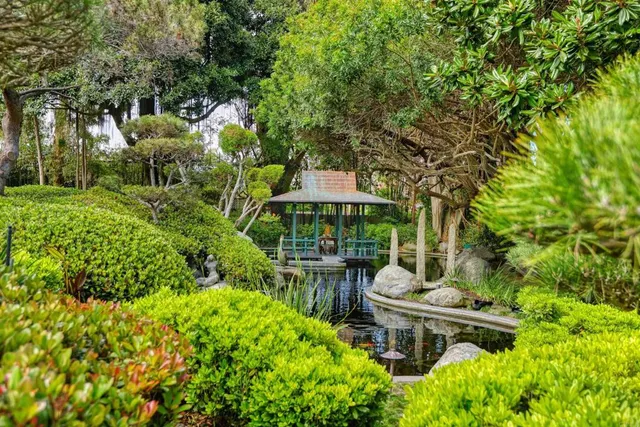 an aerial view of a house with garden space and a patio