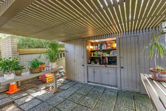 a living room with couch and a floor to ceiling window