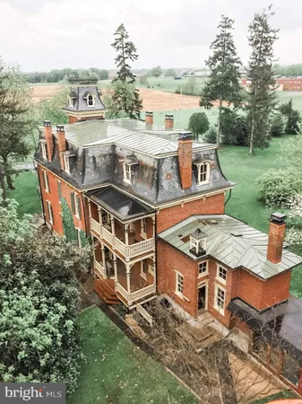 an aerial view of a house with a big yard