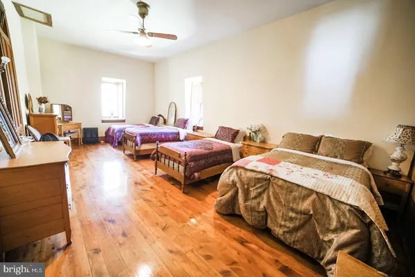 a bedroom with three beds and a chandelier