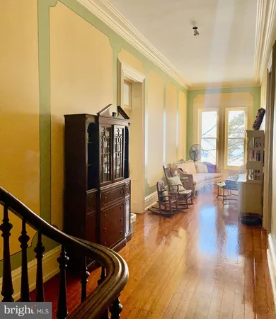 a living room with furniture windows and a wooden floor