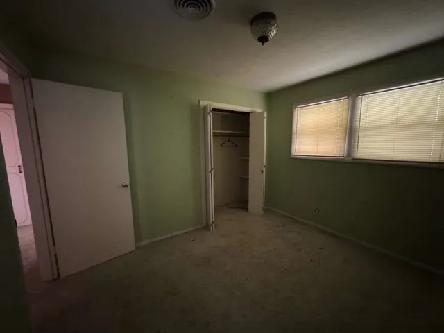 an empty room with a empty space and windows