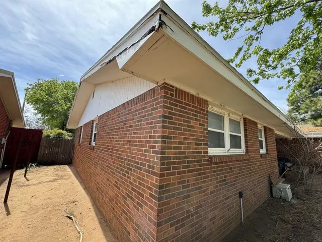 a backyard of a house with a tree