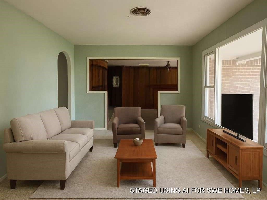 104 East 19th Street Littlefield, TX 79339 - Photo 8 of 19 a living room with furniture a flat screen tv and a fireplace