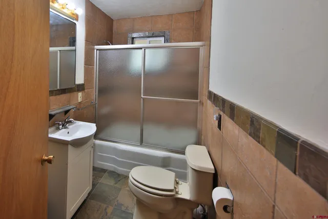 a bathroom with a sink a mirror and a shower