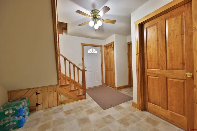a bedroom with a bed chandelier and a window