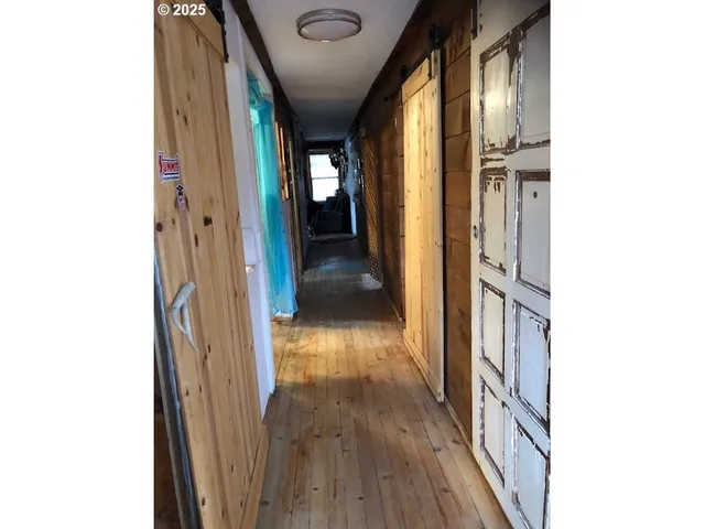 a view of hallway with wooden floor