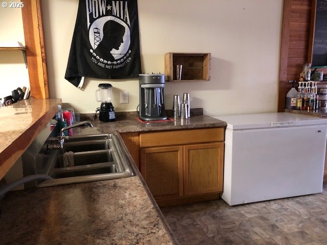 150 East Franklin Avenue Dayville, OR 97825 - Photo 25 of 33 a kitchen with a sink and a stove with wooden floor