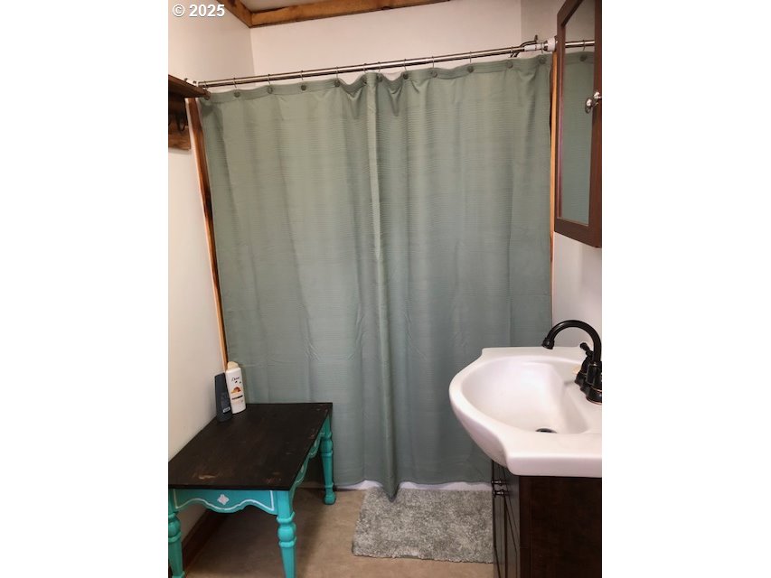 150 East Franklin Avenue Dayville, OR 97825 - Photo 29 of 33 a bathroom with a sink and mirror