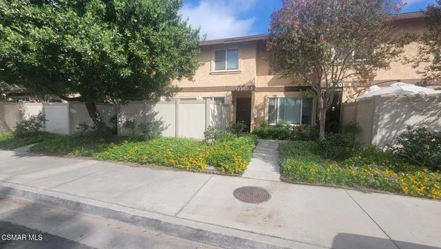 a front view of house with yard and trees around