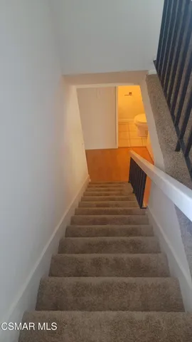 a bathroom with a toilet and a mirror