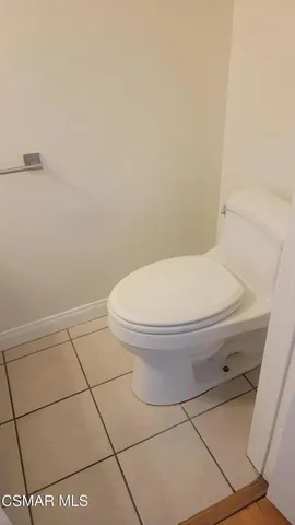 a white toilet sitting next to a white tub