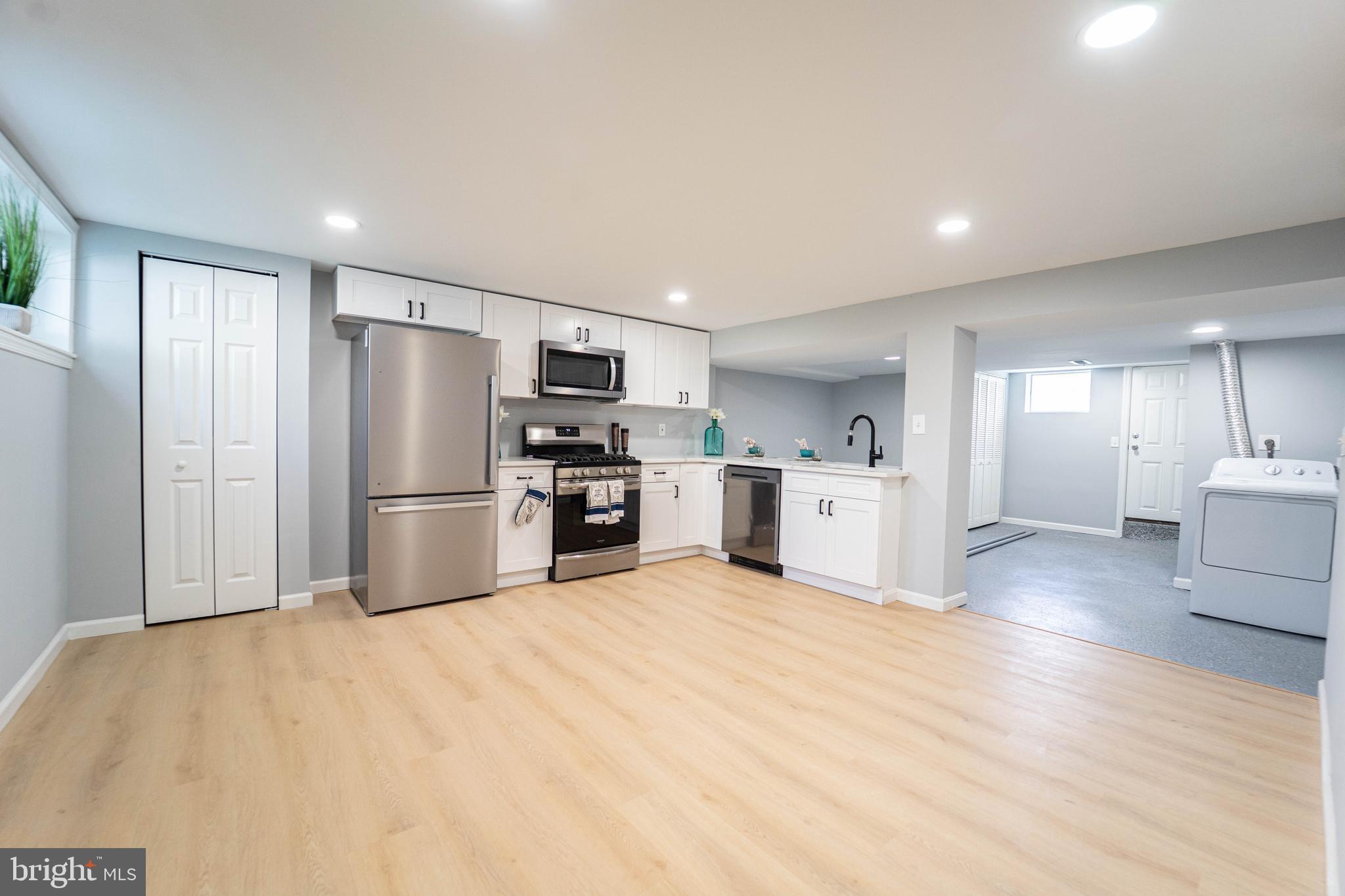 2841 Federal Street Baltimore, MD 21213 - Photo 14 of 39 a kitchen with a refrigerator a sink and a stove top oven