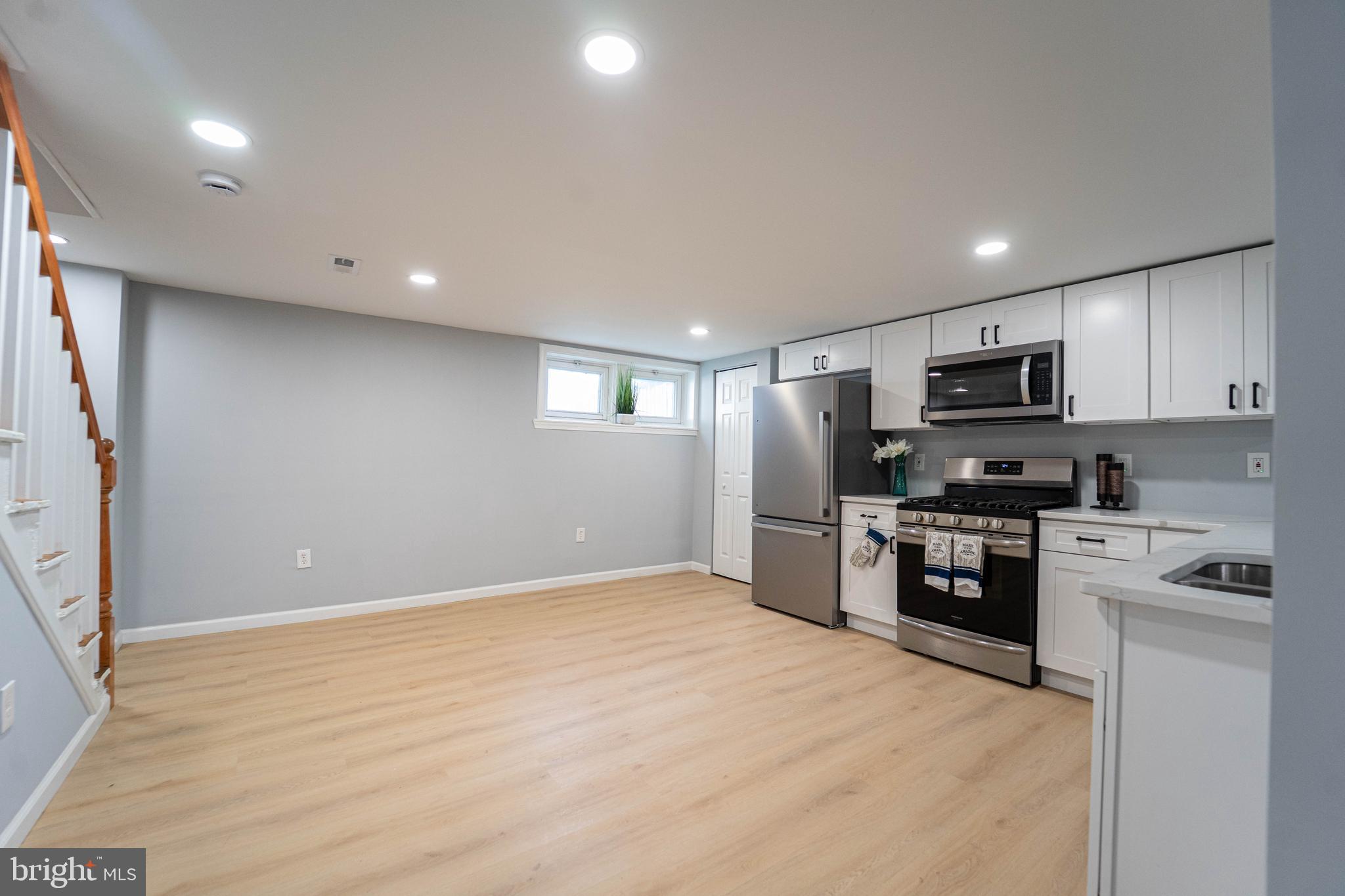 2841 Federal Street Baltimore, MD 21213 - Photo 17 of 39 a kitchen with granite countertop a refrigerator stove top oven and sink