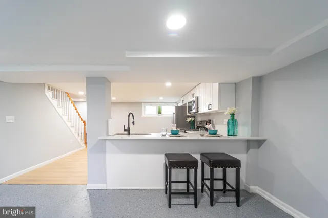 a kitchen with a table and chairs in it