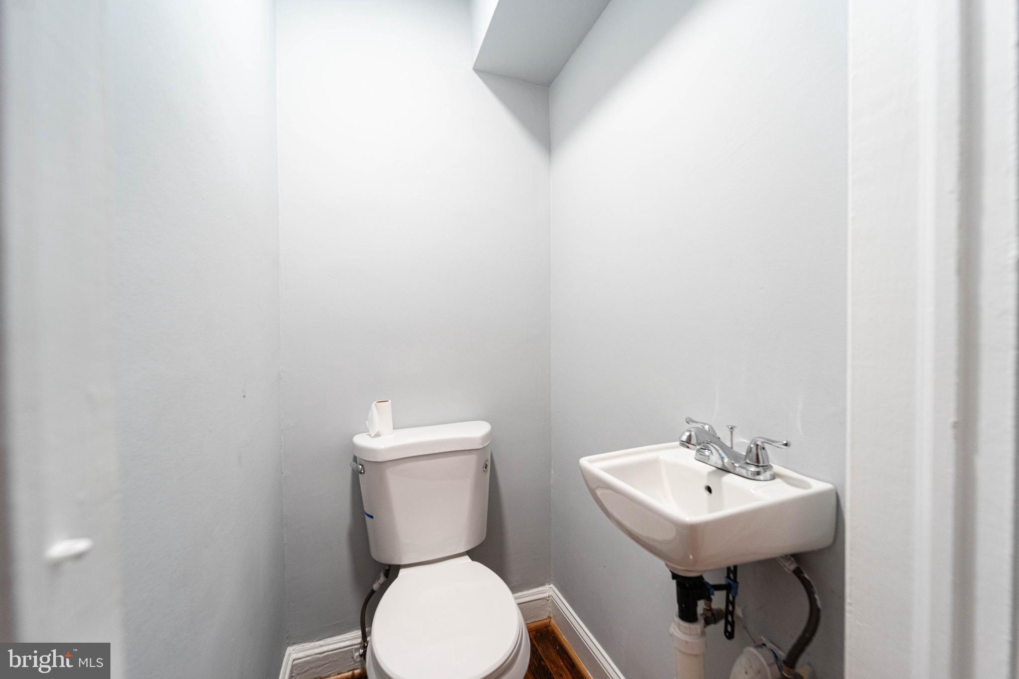 2841 Federal Street Baltimore, MD 21213 - Photo 10 of 39 a white toilet sitting next to a white sink