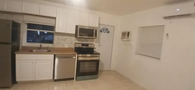 a kitchen with stainless steel appliances a sink stove and refrigerator