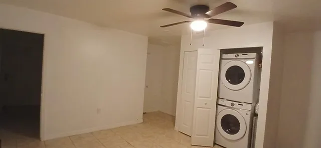 a view of a storage and utility room with washer and dryer