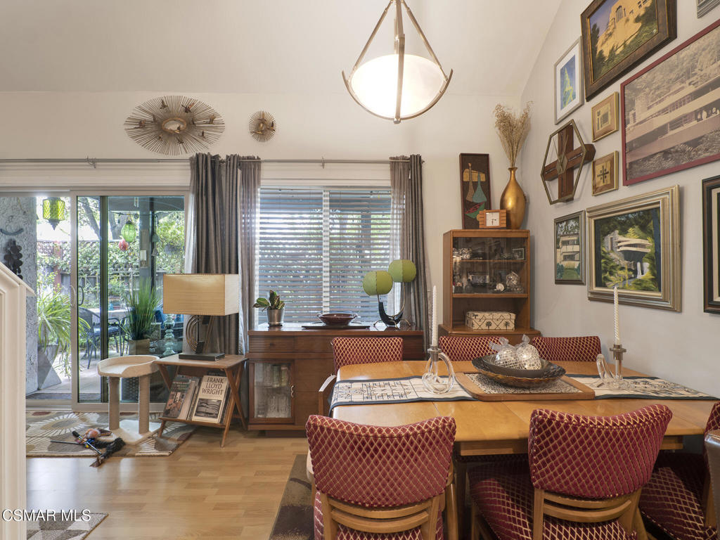 24829 Apple Street, Unit E Newhall, CA 91321 - Photo 11 of 29 a dining room with furniture a chandelier and wooden floor