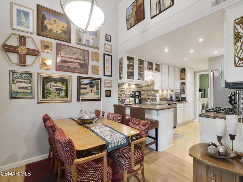 24829 Apple Street, Unit E Newhall, CA 91321 - Photo 12 of 29 a dining room with stainless steel appliances granite countertop a dining table and chairs