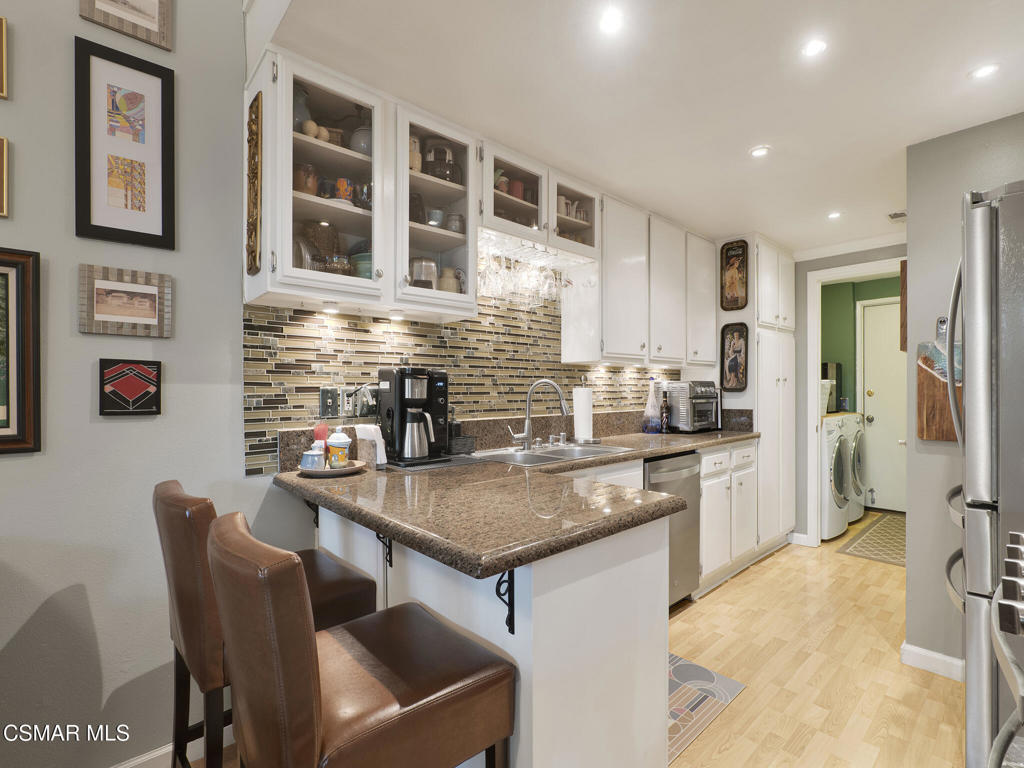 24829 Apple Street, Unit E Newhall, CA 91321 - Photo 13 of 29 a kitchen with stainless steel appliances granite countertop a sink and a refrigerator