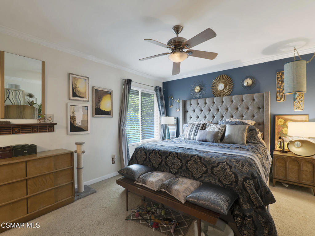 24829 Apple Street, Unit E Newhall, CA 91321 - Photo 19 of 29 a bedroom with a bed and a chandelier