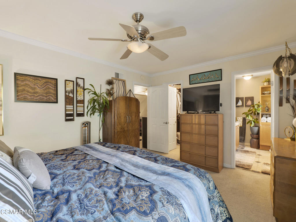 24829 Apple Street, Unit E Newhall, CA 91321 - Photo 20 of 29 a bedroom with a balcony a bed and a flat screen tv