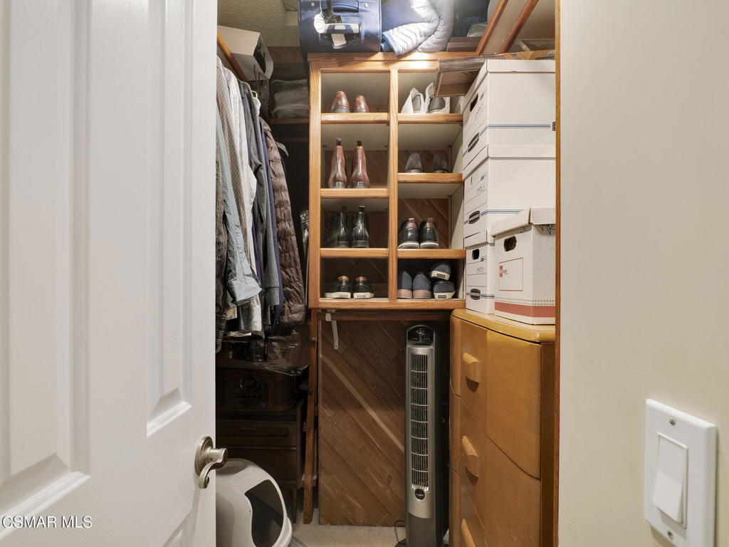 24829 Apple Street, Unit E Newhall, CA 91321 - Photo 23 of 29 a view of walk in closet with clothes and shoes
