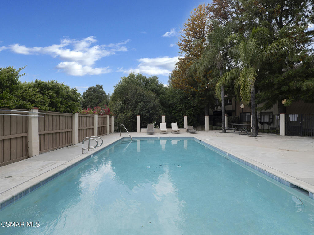 24829 Apple Street, Unit E Newhall, CA 91321 - Photo 27 of 29 a view of a backyard with a small swimming pool
