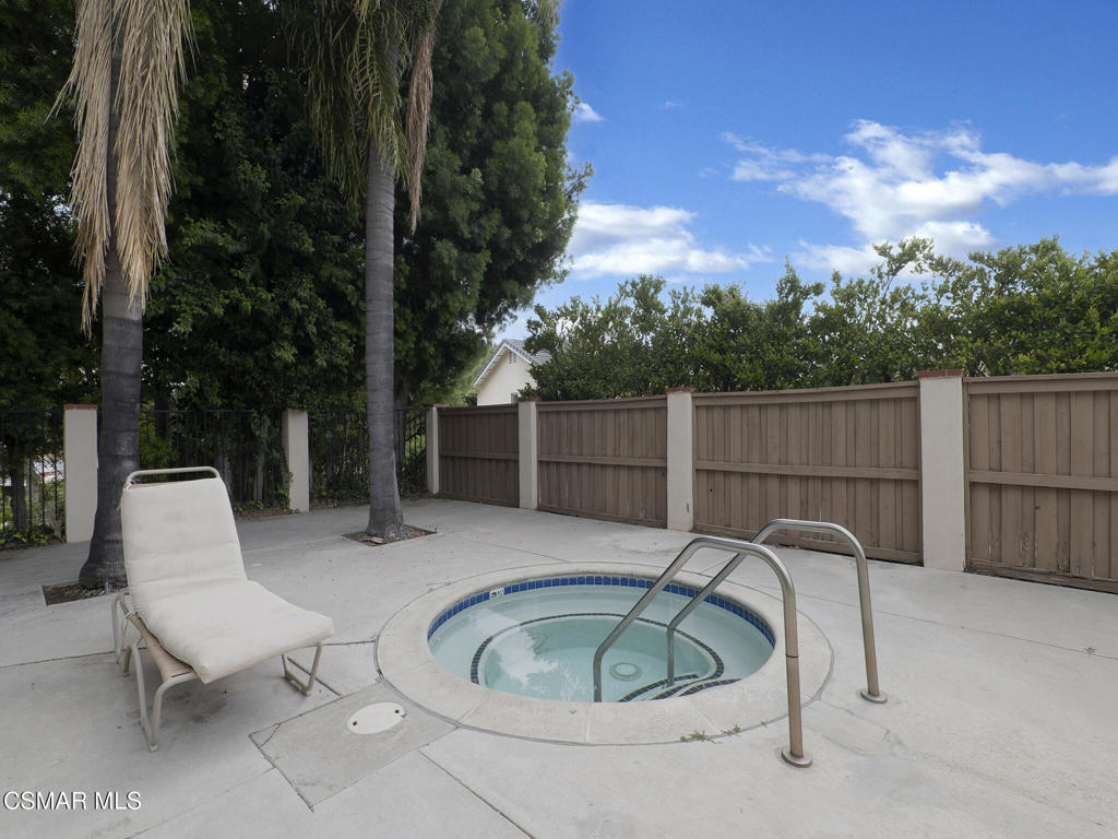 24829 Apple Street, Unit E Newhall, CA 91321 - Photo 29 of 29 a backyard of a house with table and chairs