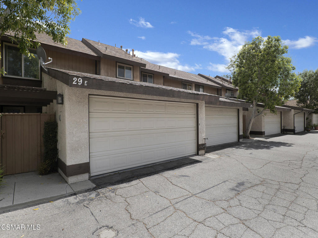 24829 Apple Street, Unit E Newhall, CA 91321 - Photo 3 of 29 a view of a parking space with windows