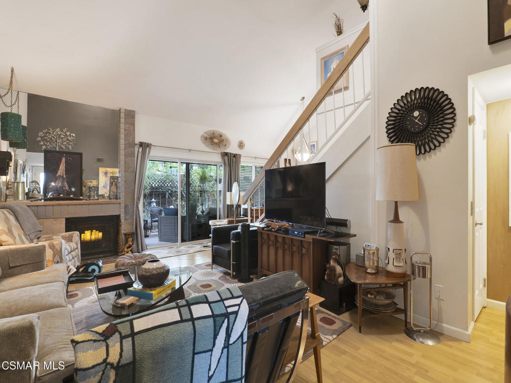 24829 Apple Street, Unit E Newhall, CA 91321 - Photo 6 of 29 a living room with furniture a flat screen tv and a fireplace