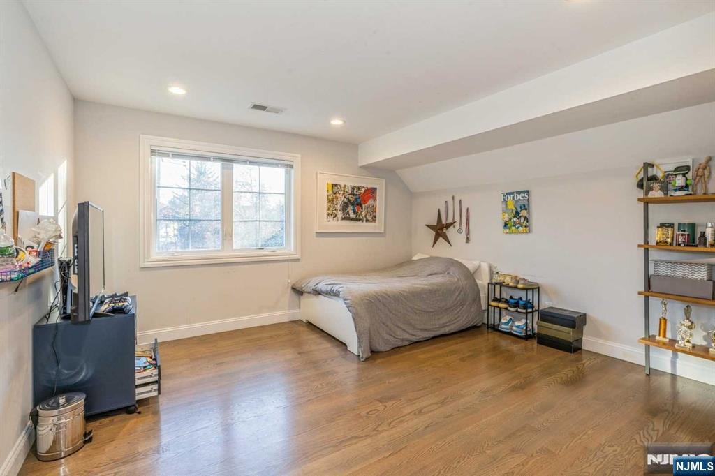 5 Benjamin Road Tenafly, NJ 07670 - Photo 11 of 50 a bedroom with a bed and wooden floor
