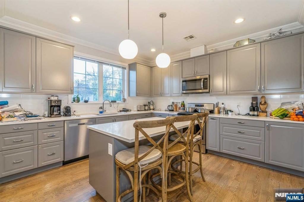5 Benjamin Road Tenafly, NJ 07670 - Photo 12 of 50 a kitchen with a center island appliances and cabinets