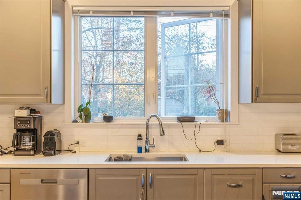 5 Benjamin Road Tenafly, NJ 07670 - Photo 17 of 50 a kitchen with sink a window and cabinets