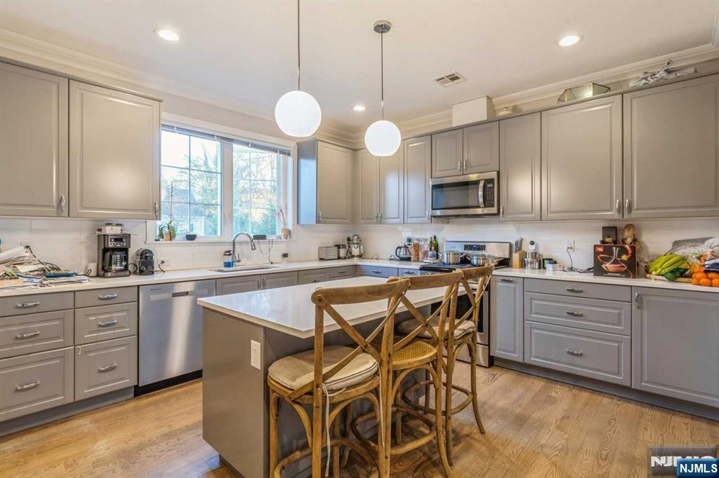 5 Benjamin Road Tenafly, NJ 07670 - Photo 19 of 50 a kitchen with cabinets a center island a window and stainless steel appliances